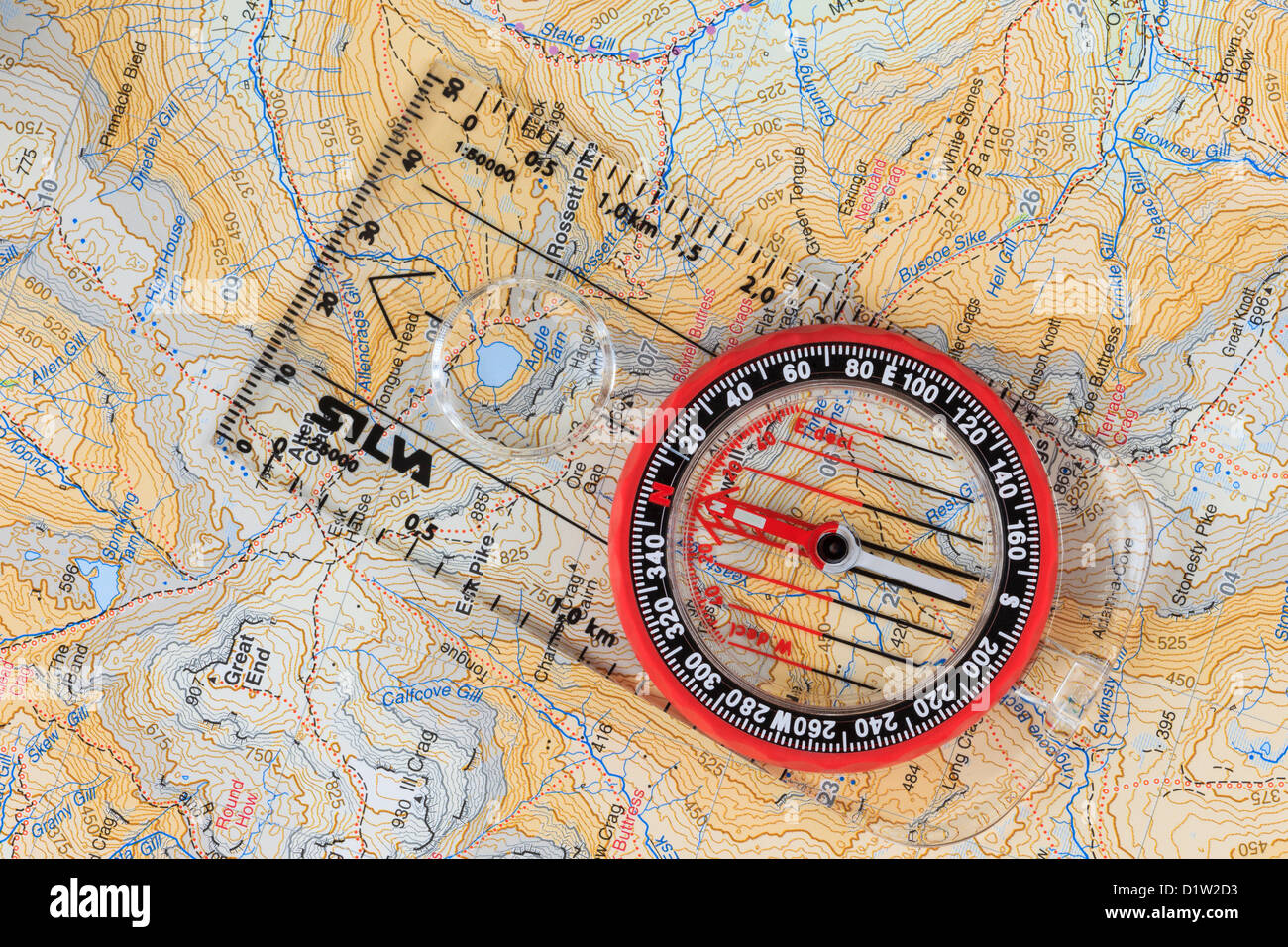 Navigation compass pointing north with grid lines on a Harvey's 1:40000 hiking and walking map and baseplate arrow pointing in direction of travel. UK Stock Photo