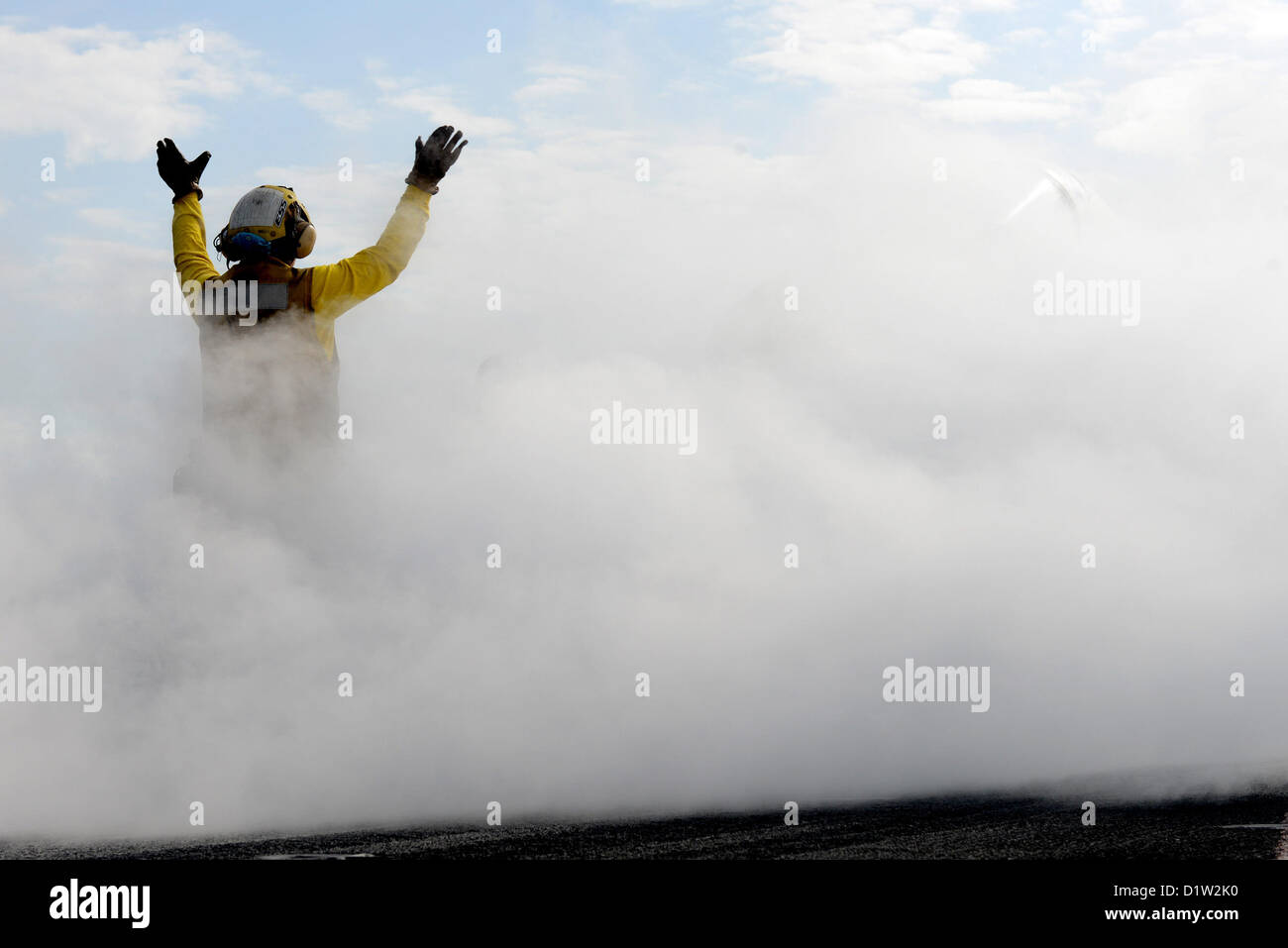 A 'shooter' (catapult/arresting gear officer) signals for the launch of an aircraft on the flight deck of the aircraft carrier USS John C. Stennis (CVN 74). John C. Stennis is deployed to the U.S. 5th Fleet area of responsibility conducting maritime security operations, theater security cooperation efforts and support missions for Operation Enduring Freedom. JAN 6, 2013 (U.S. Navy photo) Stock Photo