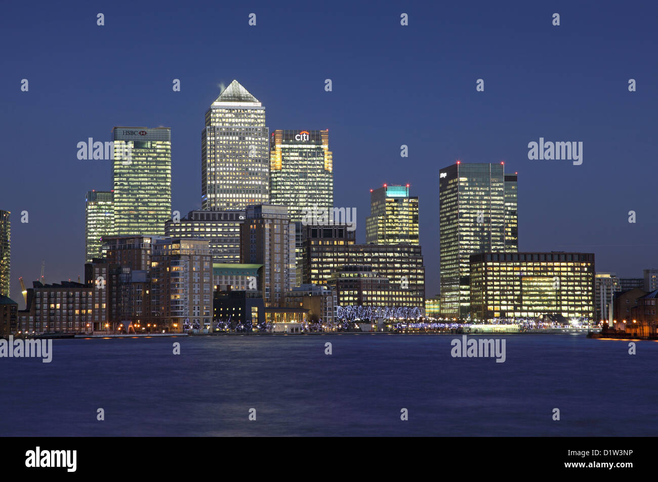 Canary Wharf development in London's docklands viewed at dusk from Limehouse with the River Thames in the foreground Stock Photo