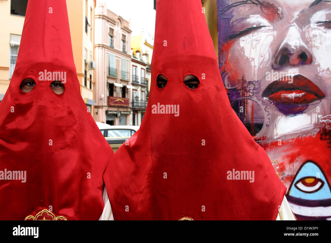 Semana Santa Seville, Holy Week. Andalucia, Spain red hooks and street art, graffiti Stock Photo