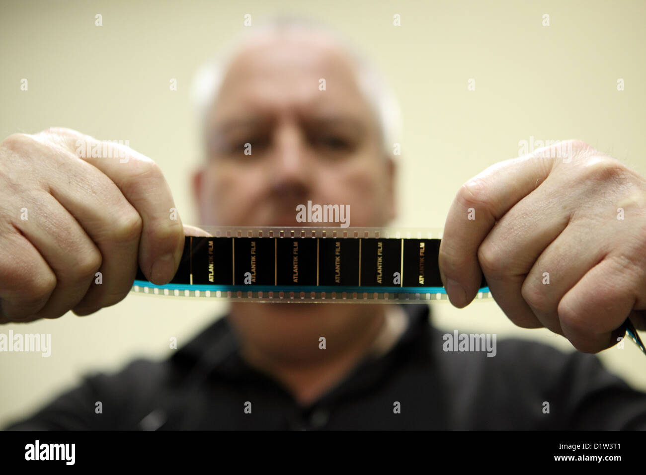 Berlin, Germany, Lutz Joergens watches a film strip Stock Photo