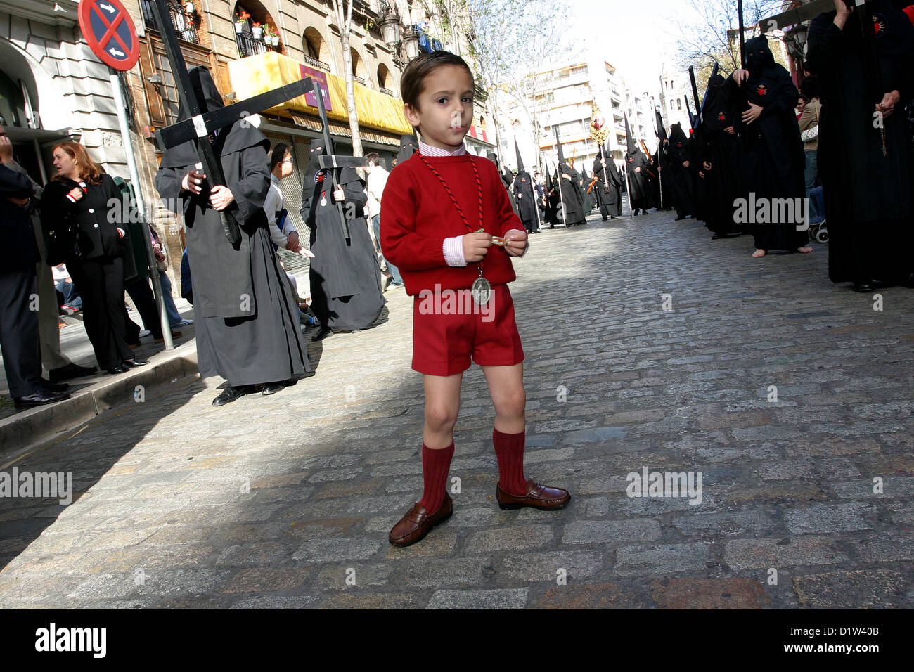 Semana Santa Seville Spain Holy Week Red child in the old city center Street procession Andalucia Stock Photo