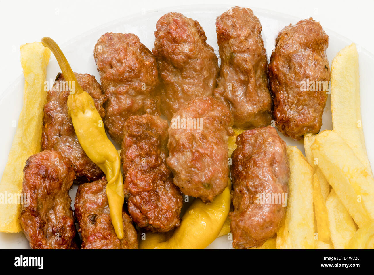 Turkish meat ball kebab inegol in the plate on white background Stock Photo
