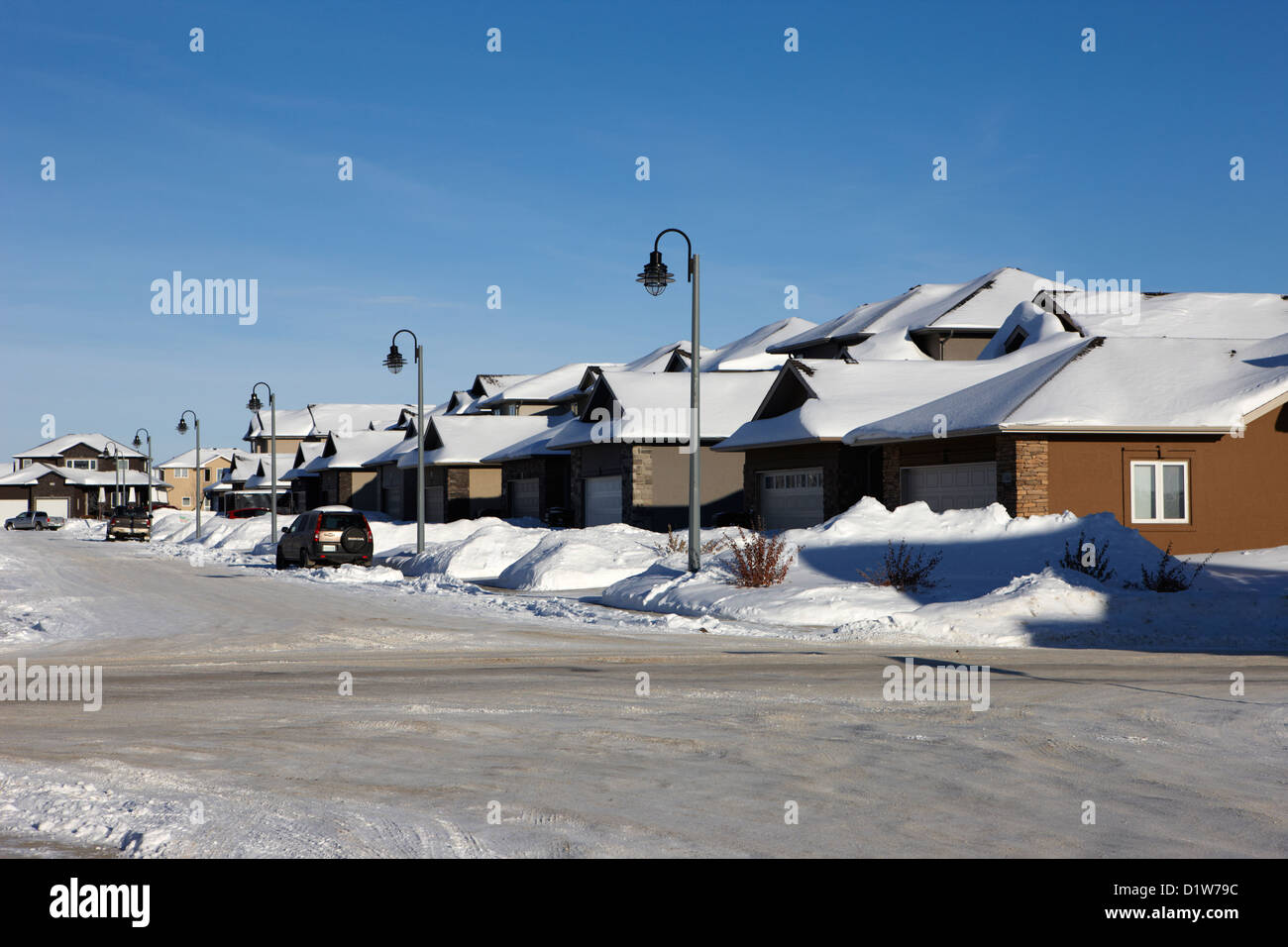 suburban houses covered in snow during bright crisp winter day Saskatoon Saskatchewan Canada Stock Photo