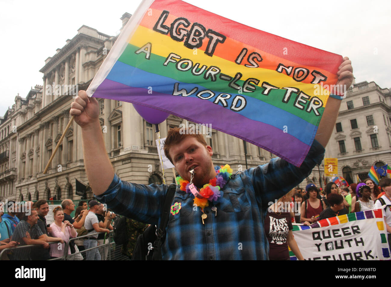 Activist with a rainbow flag at Pride London parade Stock Photo