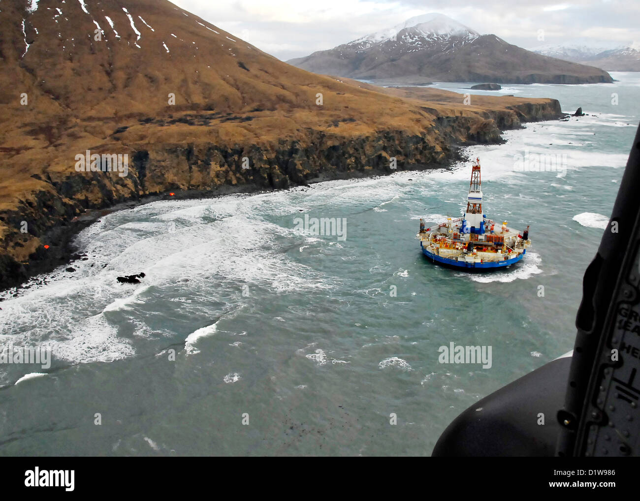 USCG oil drilling arctic platform Kodiak Kulluk MH-60 Jayhawk Alaska accident disaster tow towing energy Sitkalidak Island Royal Dutch Shell enviornmental enviornment ecology winter storm day outdoors US USA America Coast Guard rescue beached grounded waves swells aerial horizontal Stock Photo