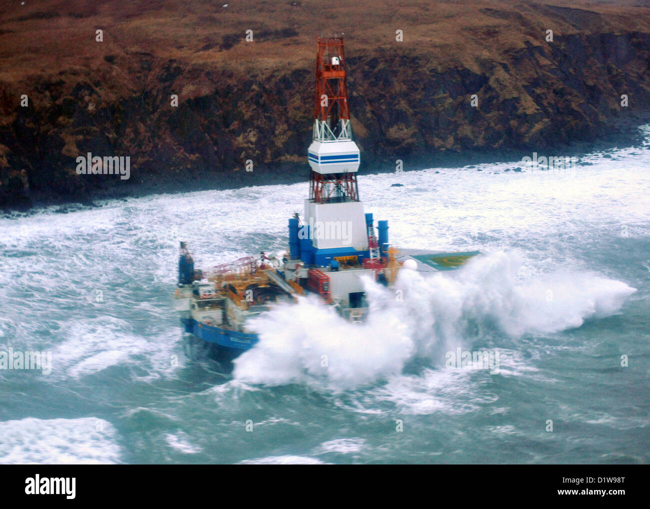 The mobile drilling unit Kulluk grounded in winter storms after breaking free of it tow January 1, 2013, 80 miles southwest of Kodiak City, Alaska. The Kulluk was floating free after the ship towing it lost power and its tow connection in the Kodiak archipelago. Stock Photo