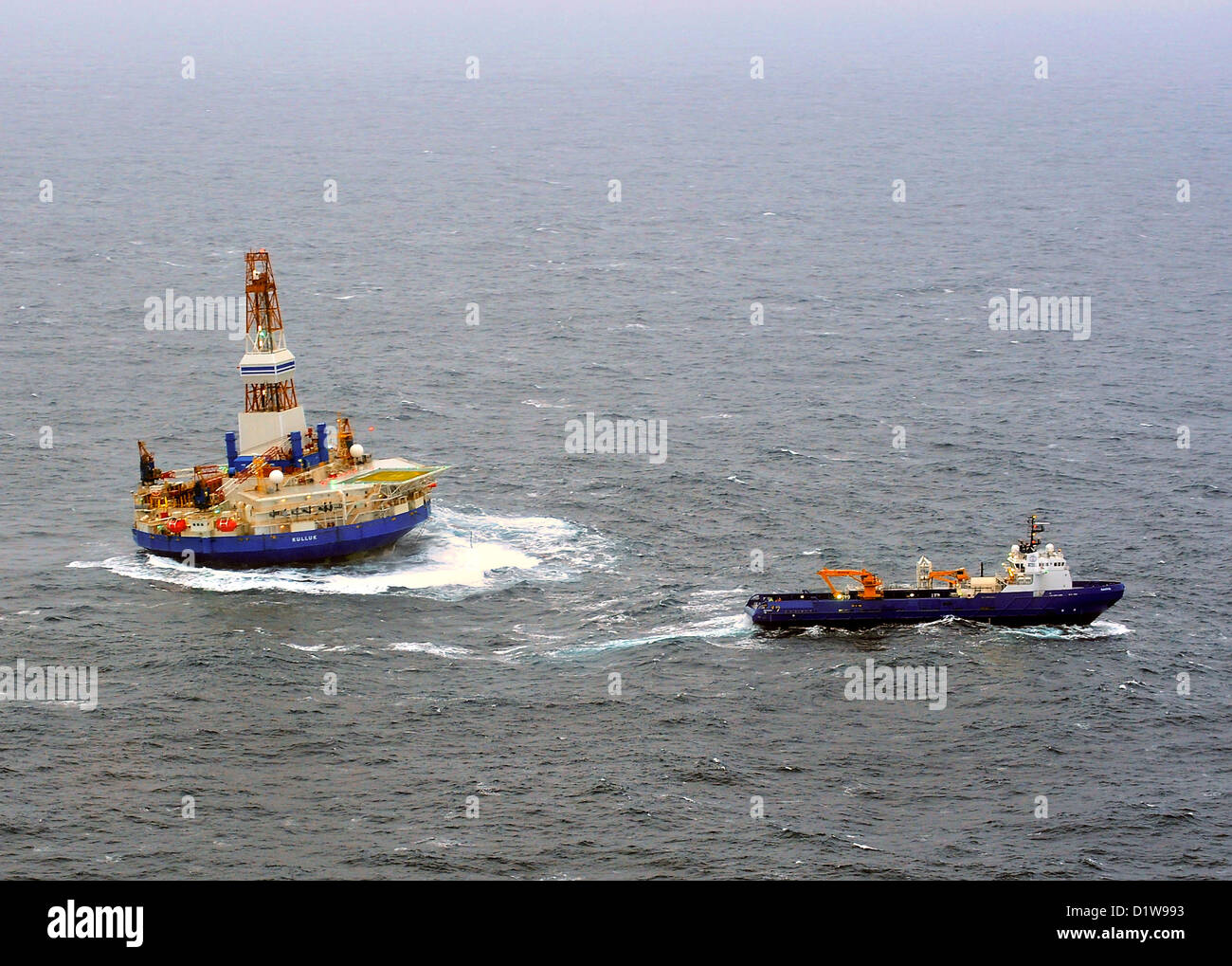 The tug boat Nanuq attempts to tow the mobile drilling platform Kulluk in 15 to 20-foot seas December 29, 2012, 80 miles southwest of Kodiak City, Alaska. The tug Aiviq lost the initial tow Thursday and suffered several engine failures resulting in US Coast Guard rescue response. Stock Photo