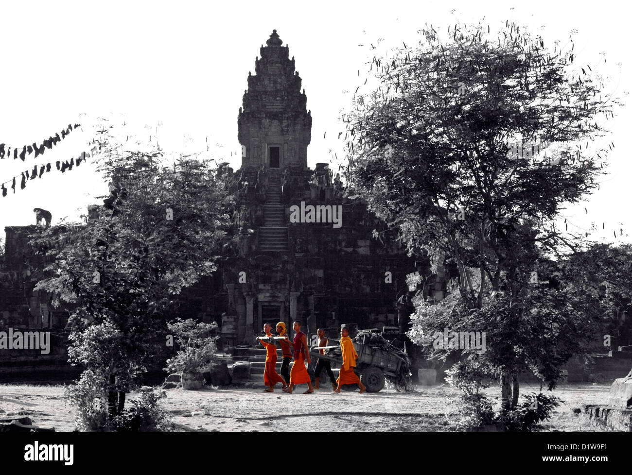 Young Buddhist monks are cleaning territory of Bakong Temple in Cambodia Stock Photo