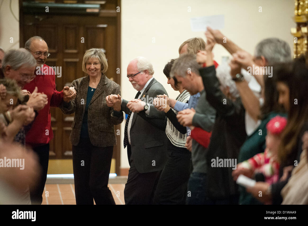 Jan. 6, 2013 - Tucson, Arizona, U.S - PAM SIMON, a former staffer for G. Giffords and Jan. 8 shooting victim, left, dances with Rep. RON BARBER (D-Ariz.) in a Tucson, Ariz. cathedral during an interfaith service commemorating the second anniversary of the 2011 shooting that killed six and wounded 13 others. (Credit Image: © Will Seberger/ZUMAPRESS.com) Stock Photo