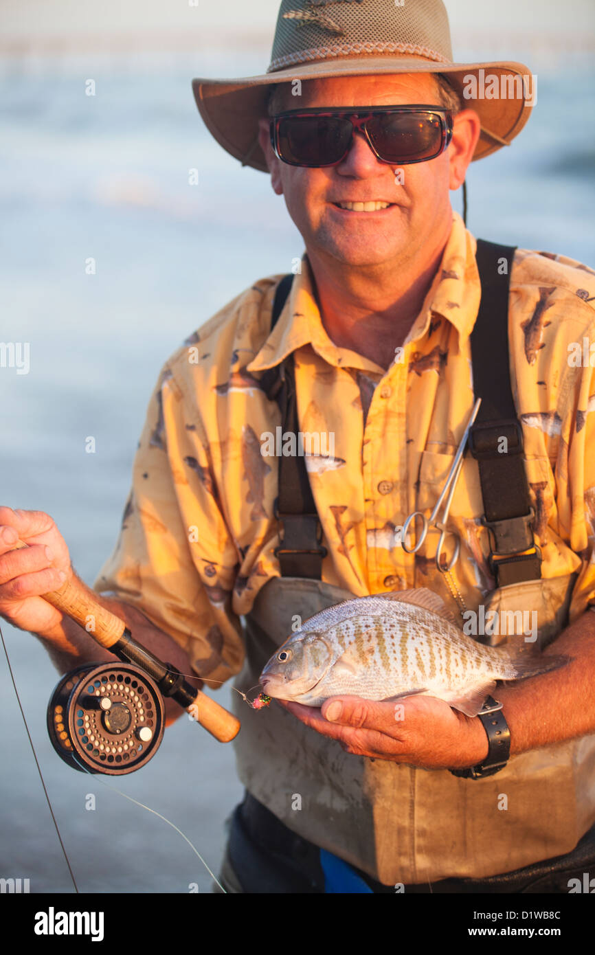 fly fisherman catching surf perch, La Conchita Beach near Carpinteria