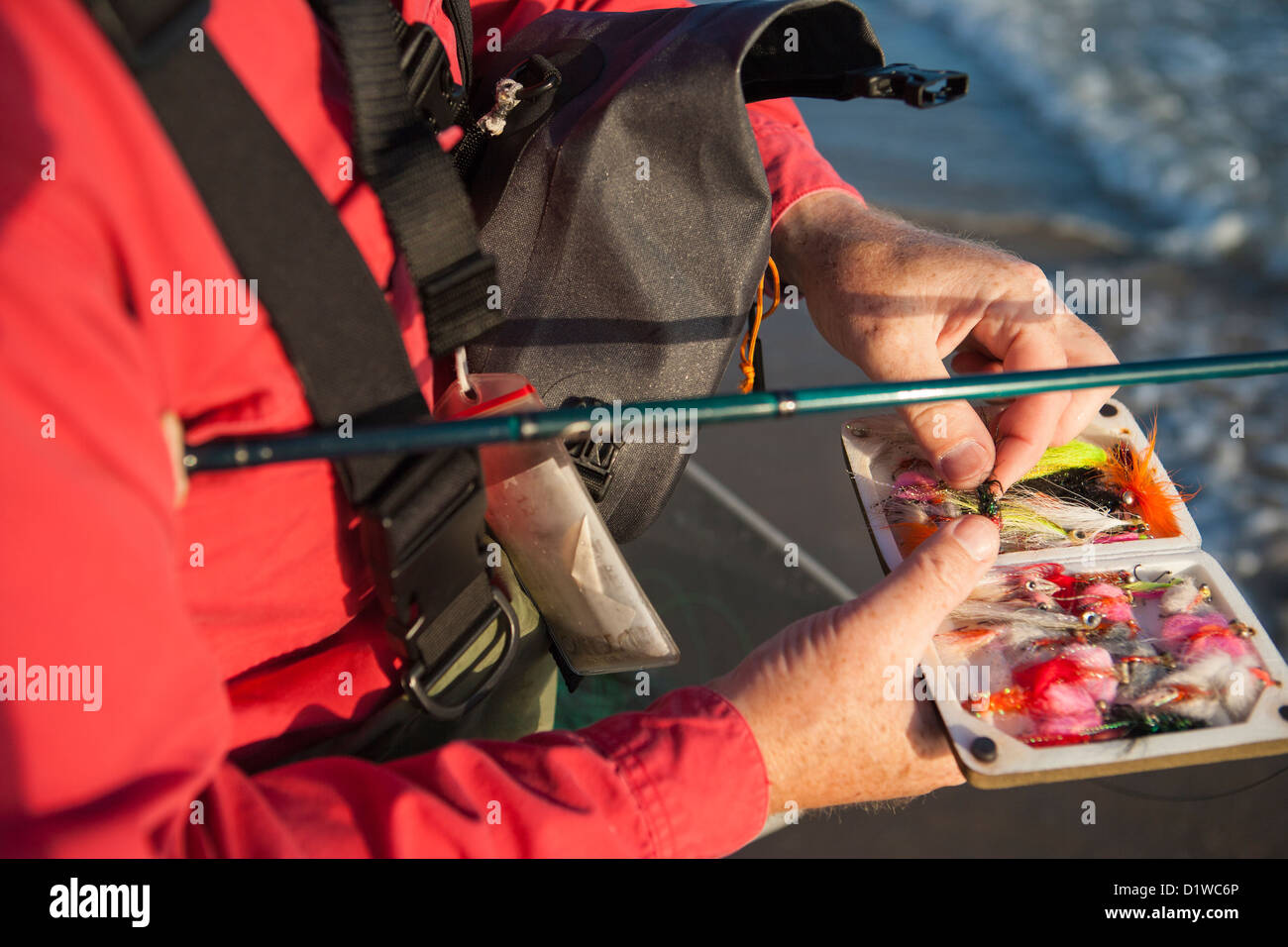 selecting a fly to fly fish for perch at Padaro Beach, Carpinteria