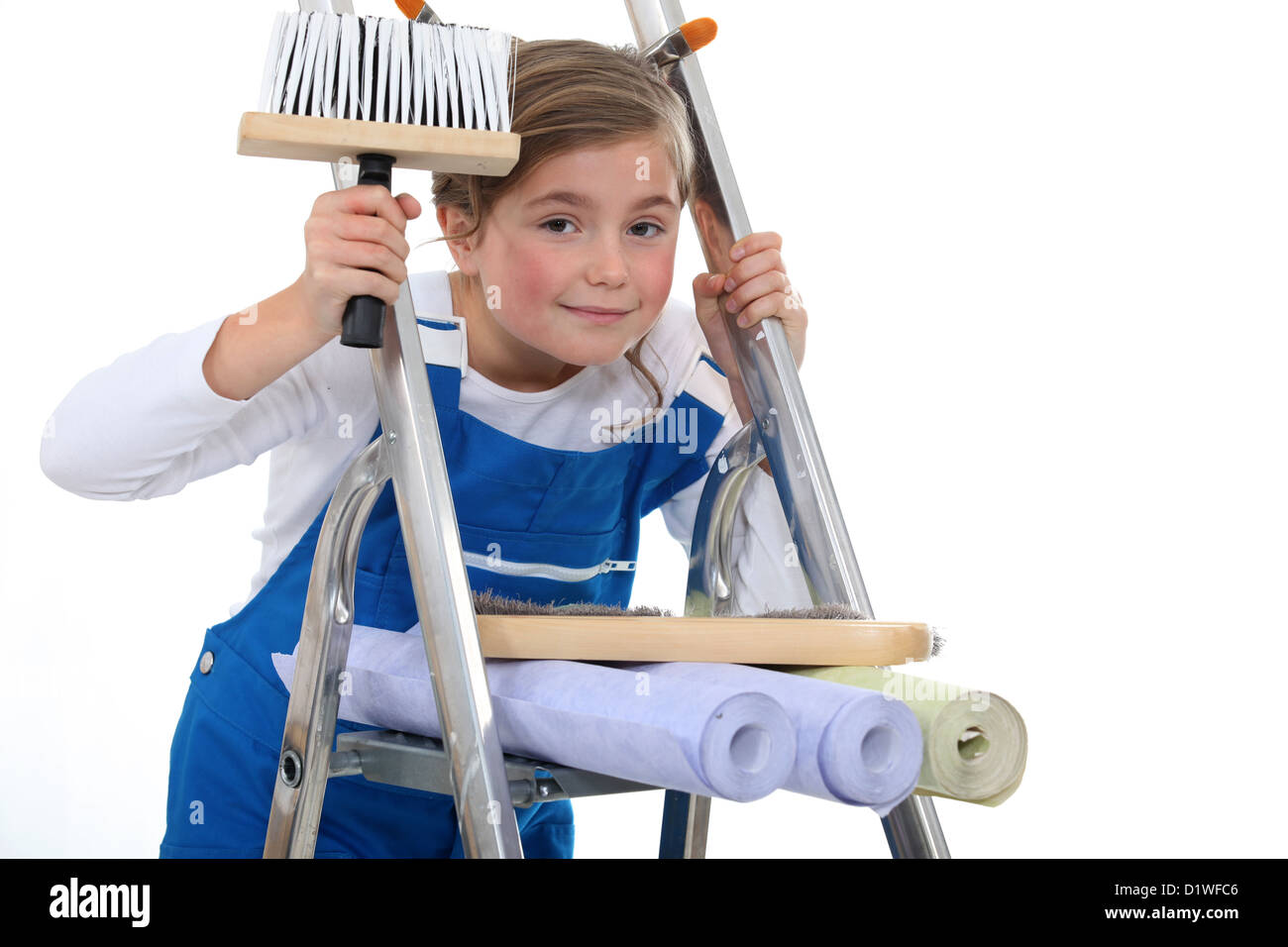 little girl on a ladder holding a brush and wallpapers Stock Photo Alamy
