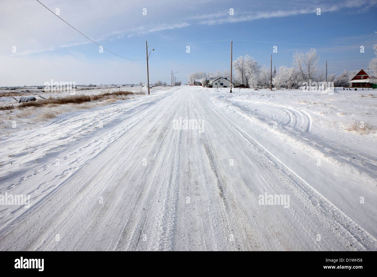 snow covered road in small rural farming community village Forget Saskatchewan Canada Stock Photo