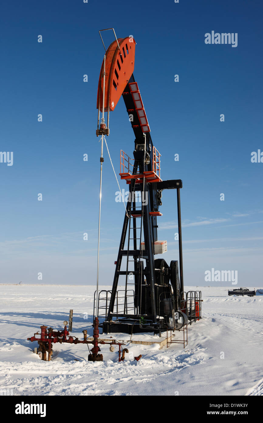 oil pumpjack in winter snow Forget Saskatchewan Canada Stock Photo