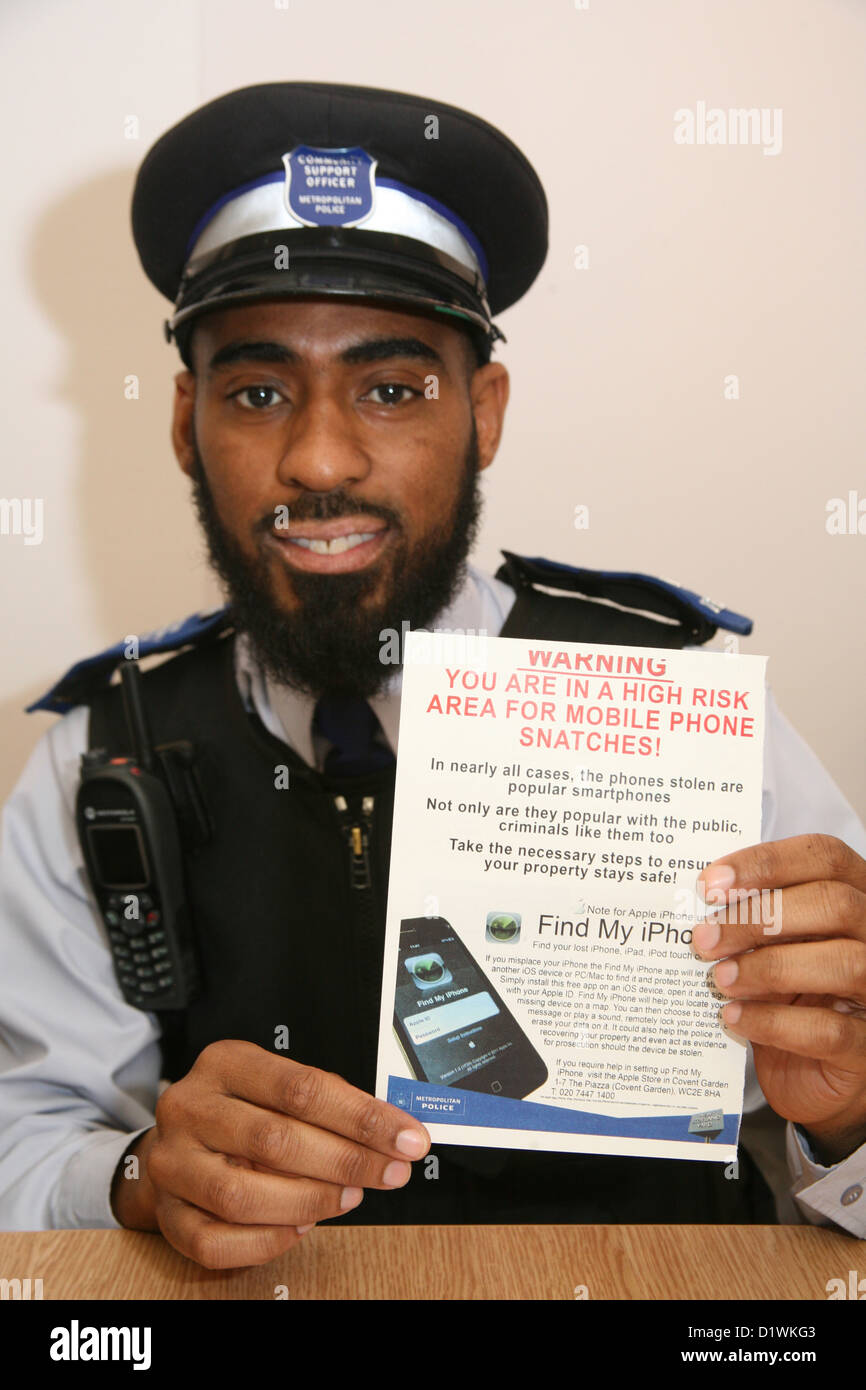 Community Police Officer displaying advice leaflet on crime prevention Stock Photo