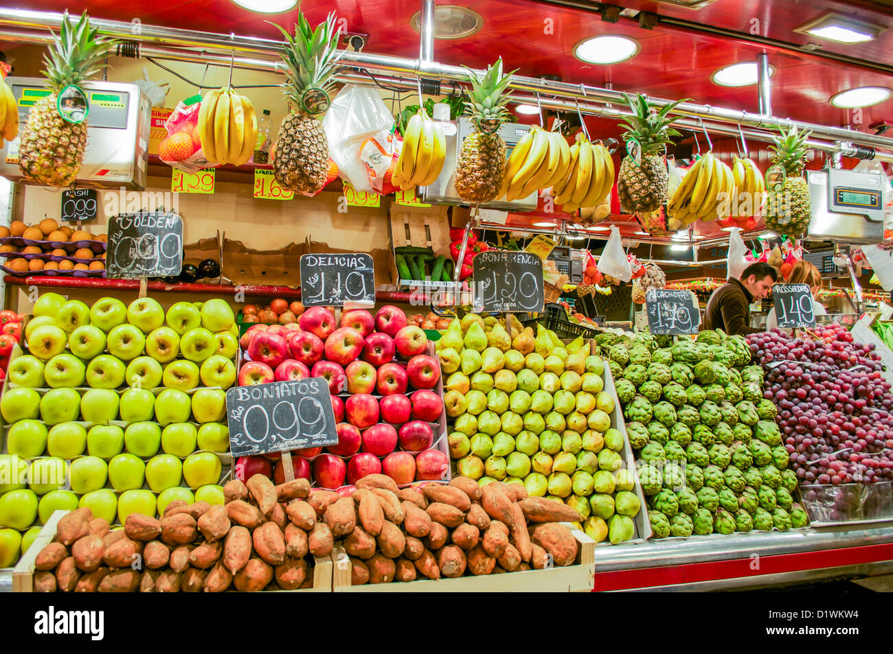 A man sells produce in his shop at the Boqueria Market in Barcelona