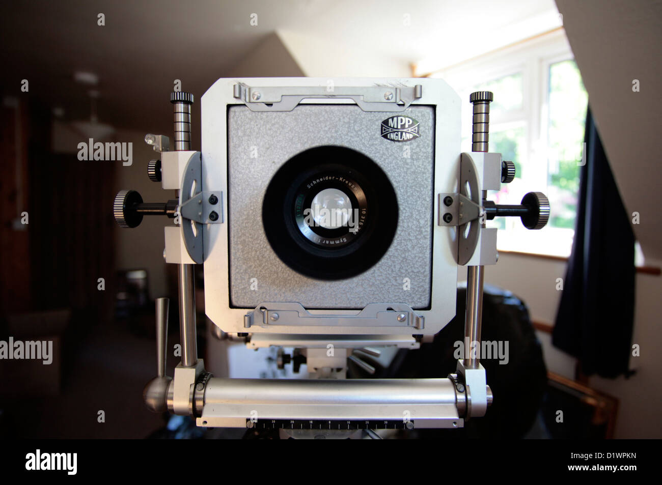 A large format film camera on a wooden tripod. Stock Photo