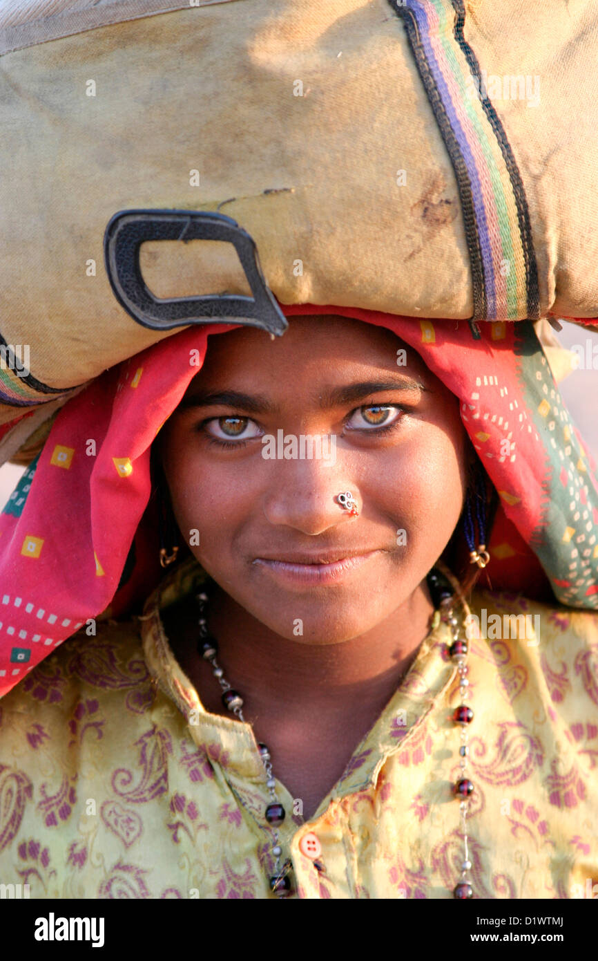 Portrait of a beautiful Rajasthani woman wearing traditional colourful ...