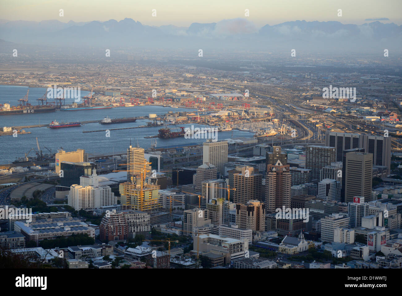 Evening aerial shot of Cape Town city centre, harbour and Hottentots Holland  mountains in background. Stock Photo