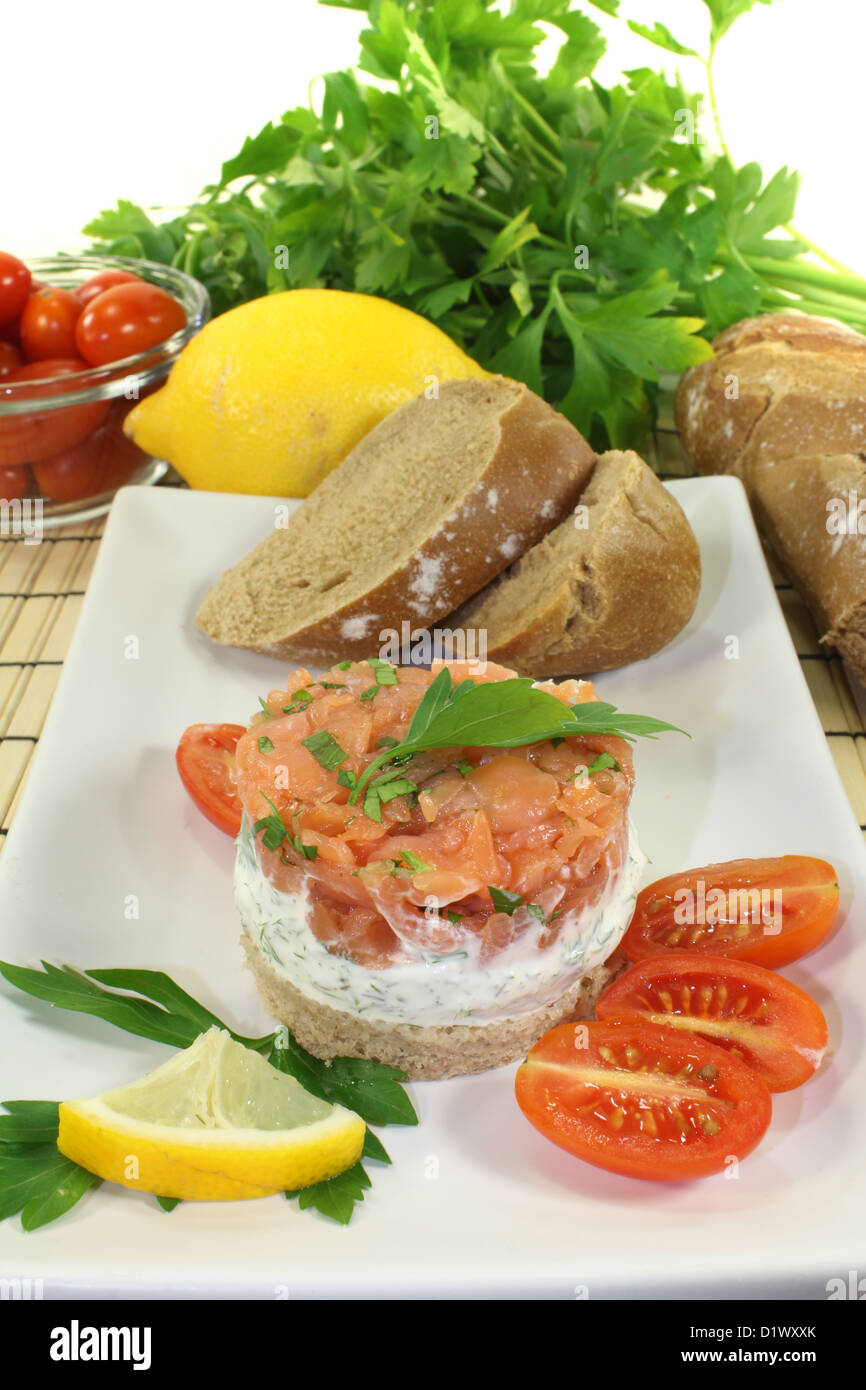fresh salmon tartare with creme fraiche, bread and parsley Stock Photo