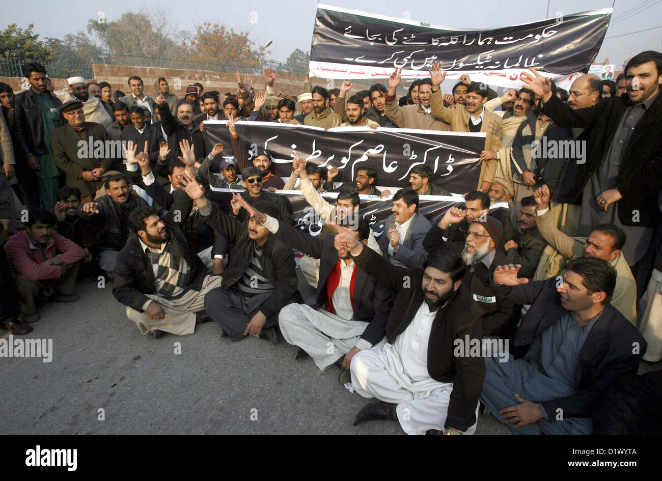 Members of CNG Stations Owners Association chant  slogans and Government and demanding immediate termination of Prime Minister Advisor for  Petroleum and Natural Resources, Dr. Asim Hussain during a protest demonstration at Peshawar  press club on Monday, January 07, 2013. Stock Photo