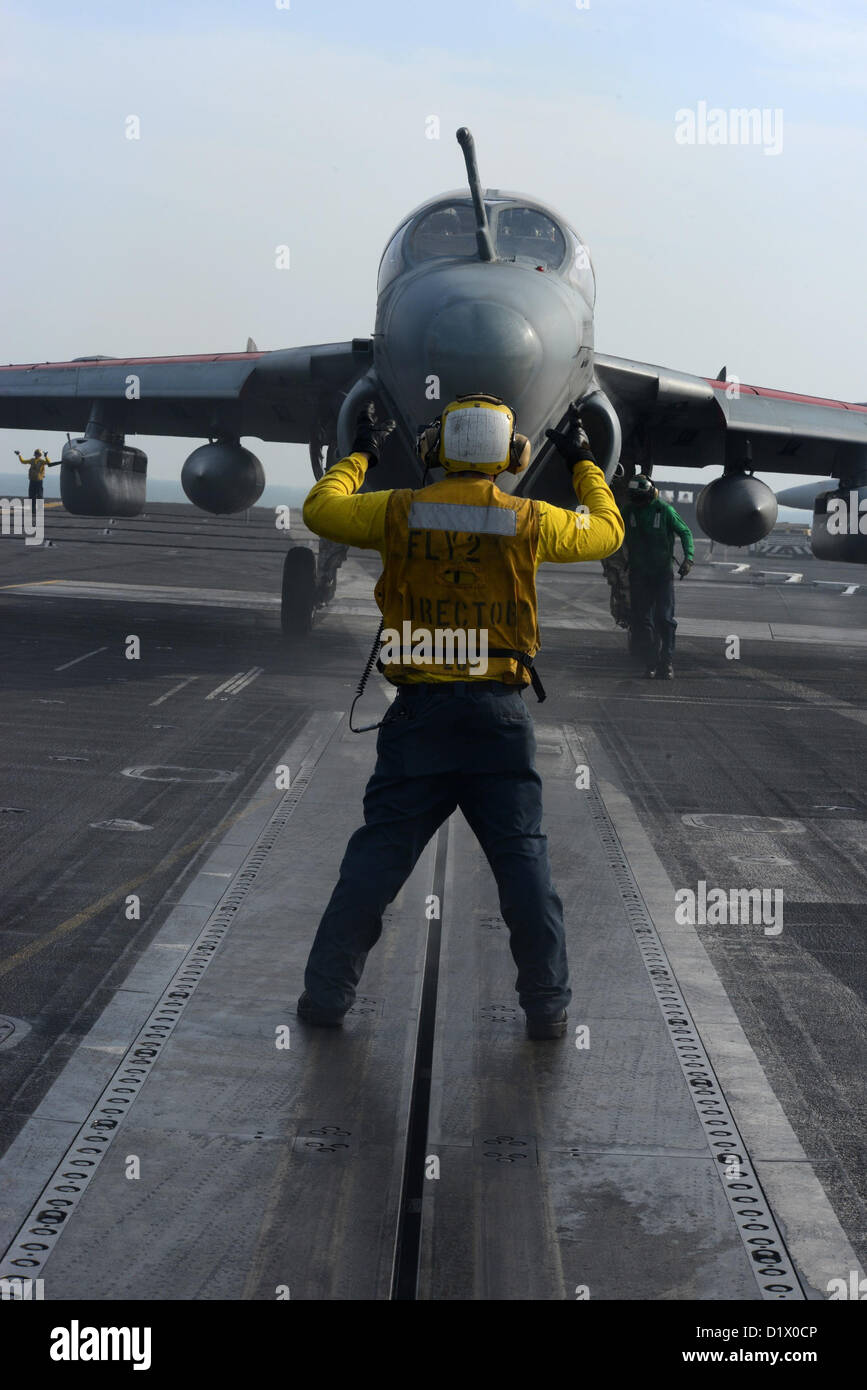 U.S. 5TH FLEET AREA OF RESPONSIBILITY (JAN  7, 2013) - Aviation Boatswain's Mate (Handling) 3rd Class Eric Augustine directs an EA-6B Prowler from the Wizards of Strike Fighter Squadron (VAQ) 133 on the flight deck of aircraft carrier USS John C. Stennis (CVN 74). John C. Stennis is deployed to the U.S. 5th Fleet area of responsibility conducting maritime security operations, theater security cooperation efforts and support missions for Operation Enduring Freedom. (U.S. Navy photo by Mass Communication Specialist 2nd Class Kenneth Abbate/Released) Stock Photo