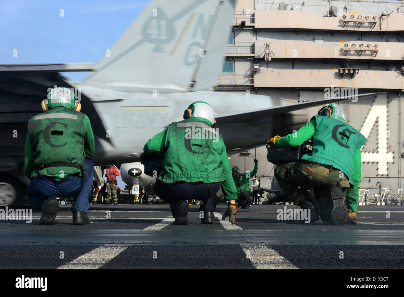 U.S. 5TH FLEET AREA OF RESPONSIBILITY (JAN  7, 2013) - Sailors observe as an F/A-18F Super Hornet of the Black Aces of Strike Fighter Squadron (VFA) 41 is launched from the flight deck of aircraft carrier USS John C. Stennis (CVN 74). John C. Stennis is deployed to the U.S. 5th Fleet area of responsibility conducting maritime security operations, theater security cooperation efforts and support missions for Operation Enduring Freedom. (U.S. Navy photo by Mass Communication Specialist 2nd Class Kenneth Abbate/Released) Stock Photo