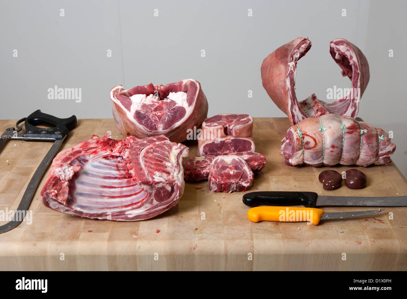 Cuts of meat from a butchered Lamb on a wooden butchers block Stock Photo