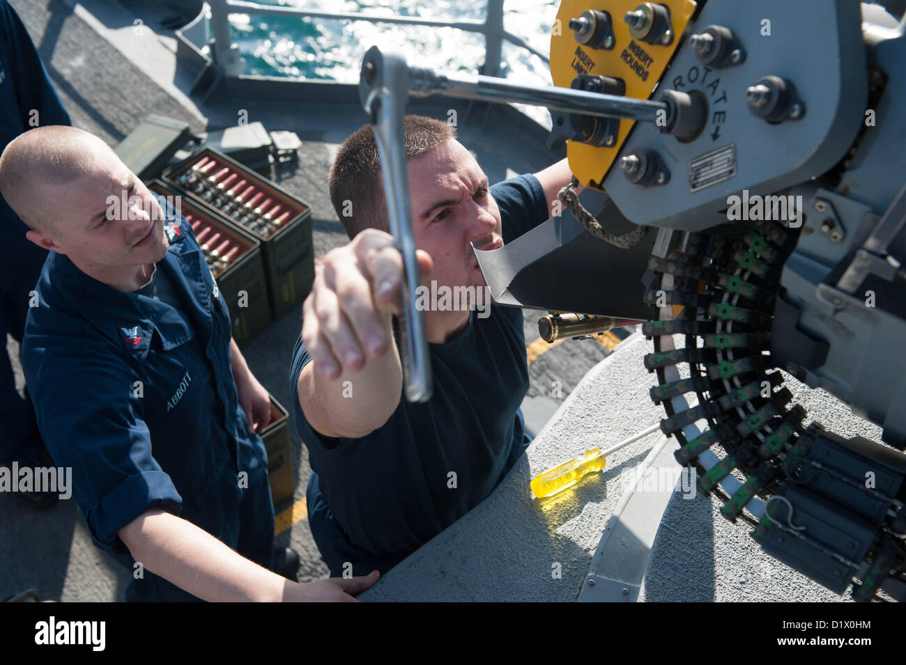(Jan. 7, 2013) ) – Fire Controlman 2nd Class Christopher Martin, from Franklin, Ky., shows Fire Controlman 2nd Class Joel Abbott, from Cleveland, Tenn., how to load rounds into a Close-In Weapons System (CIWS) aboard the Ticonderoga-class guided-missile cruiser USS Mobile Bay (CG 53). Mobile Bay is deployed with the John C. Stennis Strike Group to the U.S. 5th Fleet area of responsibility conducting maritime security operations, theater security cooperation efforts and support missions for Operation Enduring Freedom. (U.S. Navy photo by Mass Communication Specialist 2nd Class Armando Gonzales/ Stock Photo