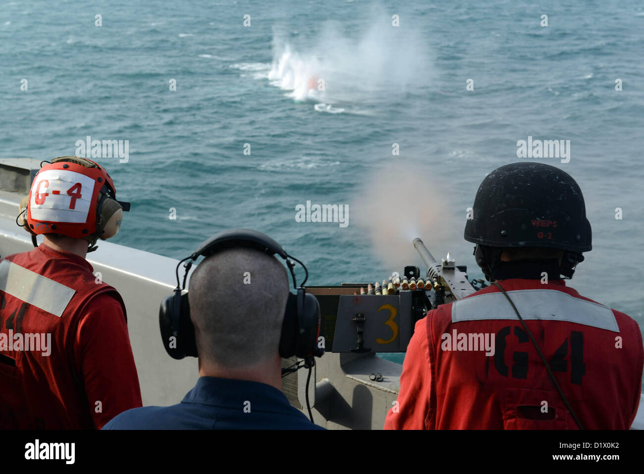 (Jan. 7, 2013)  Aviation Ordnanceman 3rd Class Donald Dorland, from Detroit, fires a .50-caliber machine gun during a crew serve weapons shoot aboard the aircraft carrier USS John C. Stennis (CVN 74). John C. Stennis is deployed to the U.S. 5th Fleet area of responsibility conducting maritime security operations, theater security cooperation efforts and support missions for Operation Enduring Freedom. (U.S. Navy photo by Mass Communication Specialist 3rd Class Chelsy Alamina/Released) Stock Photo