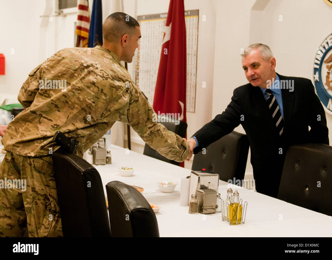 BAGRAM AIRFIELD, Afghanistan – U.S. Senator Jack Reed, senior senator for the state of Rhode Island, shakes hands with a U.S. Soldier attached to Combined Joint Task-1, 1st Infantry Division, during a constituent breakfast at Bagram Airfield, Afghanistan, Jan. 7, 2013. Reed and U.S. Senator Carl Levin, state senator for Michigan, visited troops from their respective states to boost morale and discuss U.S. efforts in Afghanistan. (U.S. Army photo by Sgt. Christopher Bonebrake, 115th Mobile Public Affairs Detachment) Stock Photo