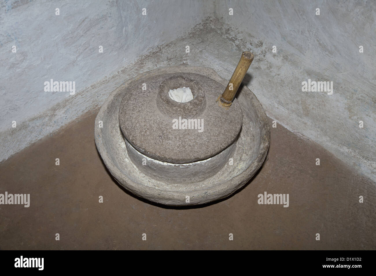 A traditional grinding stone for grain made of stone, Khalwa, Madhyapradesh, India. Stock Photo