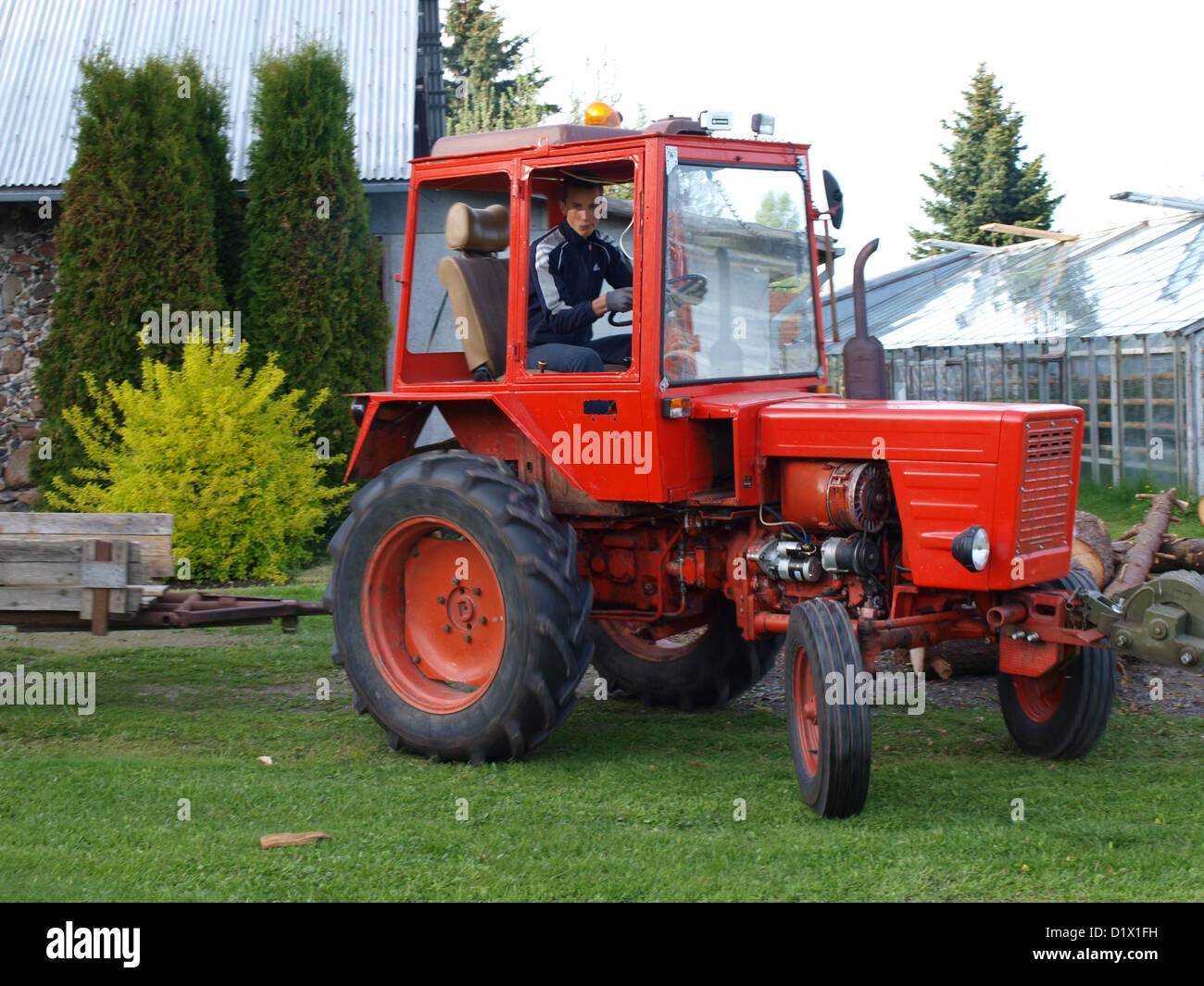 Red color soviet time russian garden tractor T-25, driver inside Stock Photo