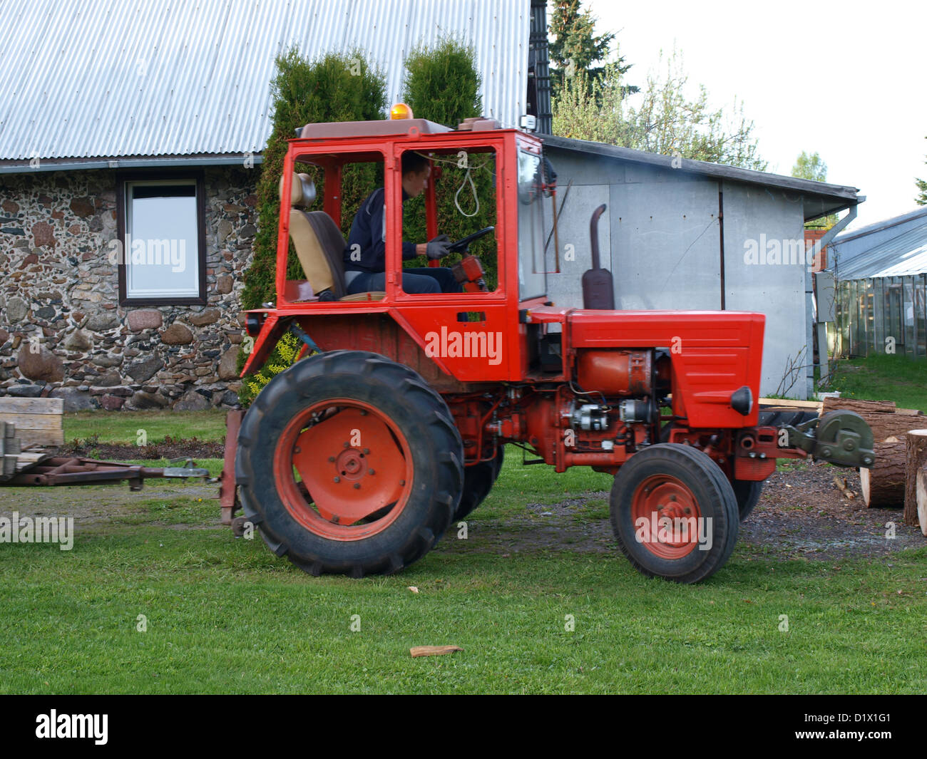 Red color russian garden tractor T-25, driver inside Stock Photo