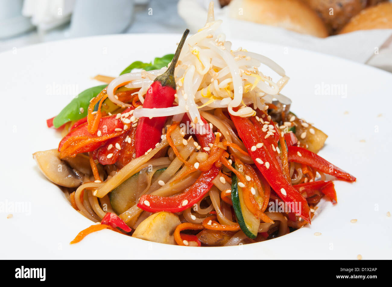 Spaghetti With Rice Model Rice spaghetti with vegetables on a white plate in a restaurant Stock ...