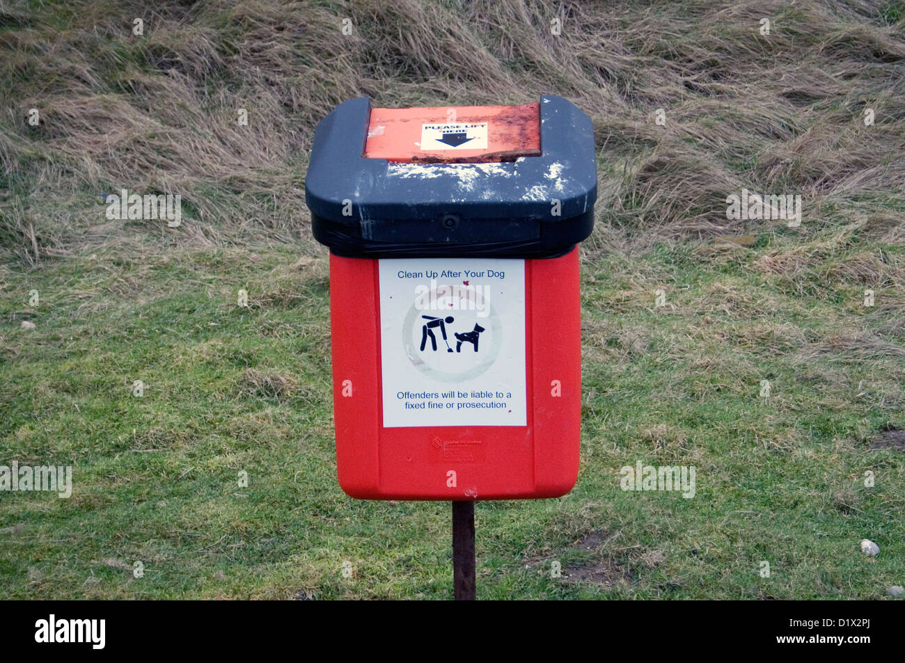 A red bin for dog walkers to use for dog feces. Stock Photo
