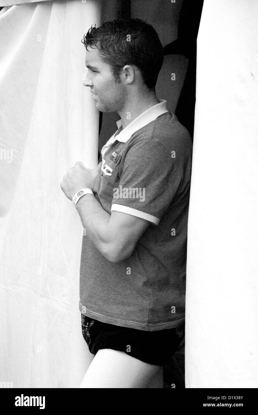 Cumberland & Westmorland Wrestler looking out of marquee at Grasmere Lakeland Sports,Lake District National Park,Cumbria, Stock Photo