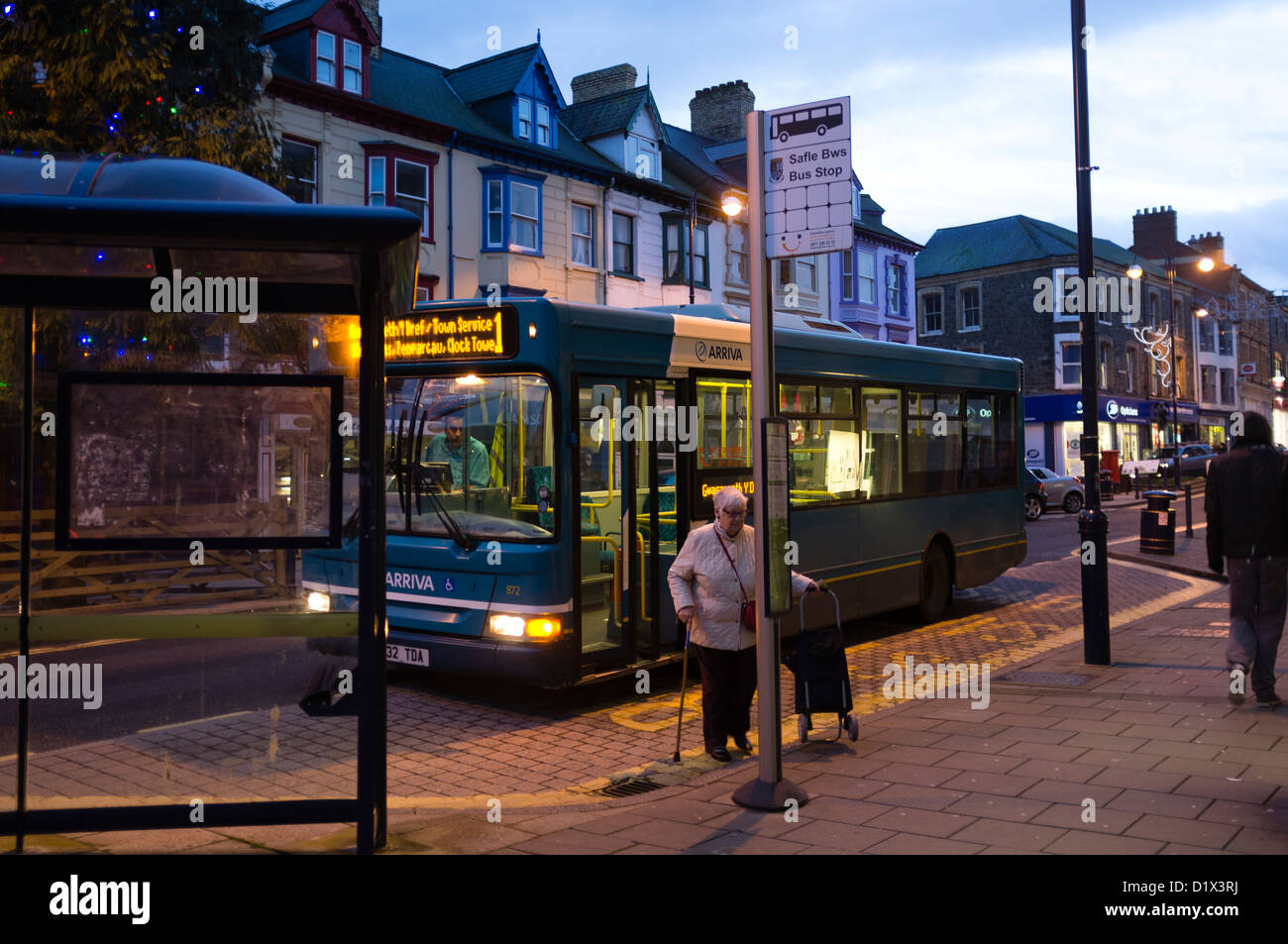 A Arriva bus at a bus stop, at night, UK Stock Photo