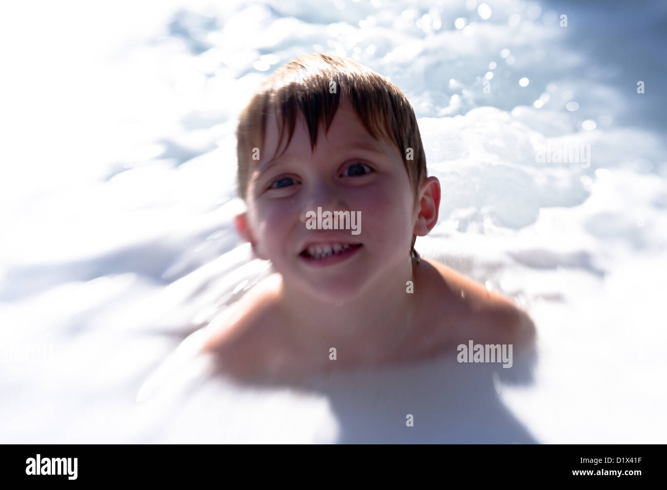 Little Boy in a Hot tub surrounded by Bubbles Stock Photo Alamy