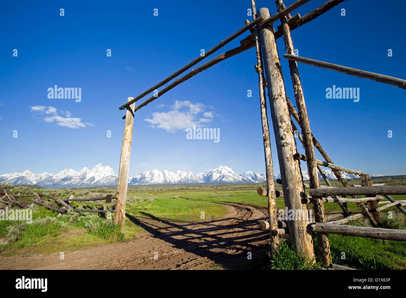 An old ranch gate frames Grand Teton National Park, Wyoming. Stock Photo