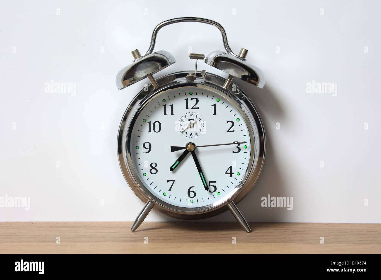 Old style chrome alarm clock with two bells. Stock Photo