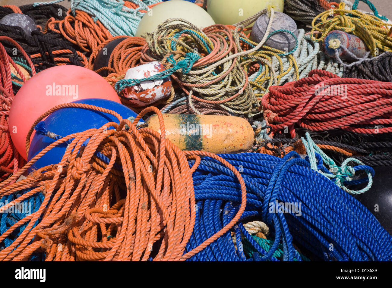 Fishing nets, ropes and buoys on the quay Stock Photo