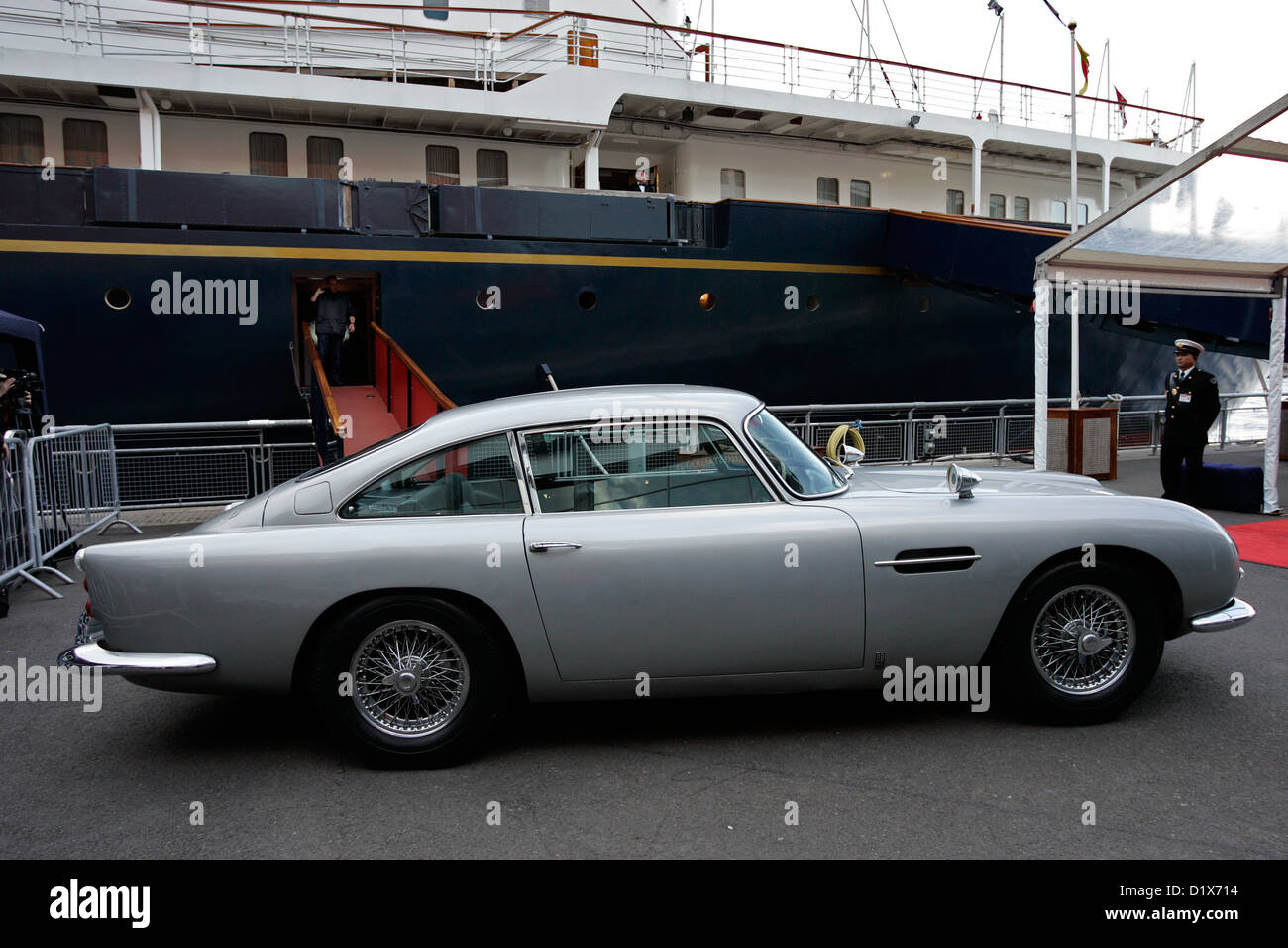 The original James Bond Aston Martin DB5 (sporting Swiss number plates) parked next to the Royal Yacht Britannia Stock Photo