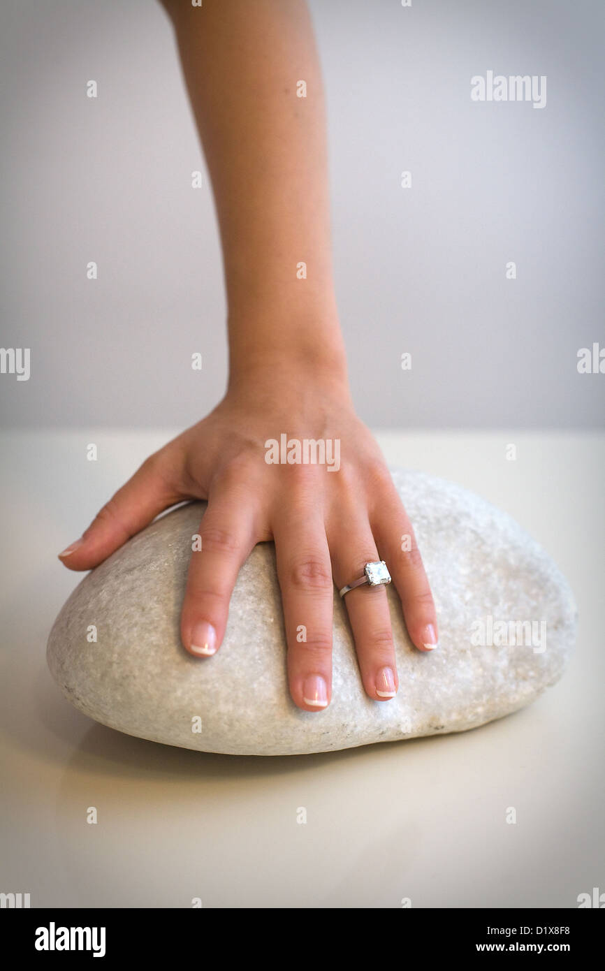 Female hand with engagement ring on stone Stock Photo - Alamy