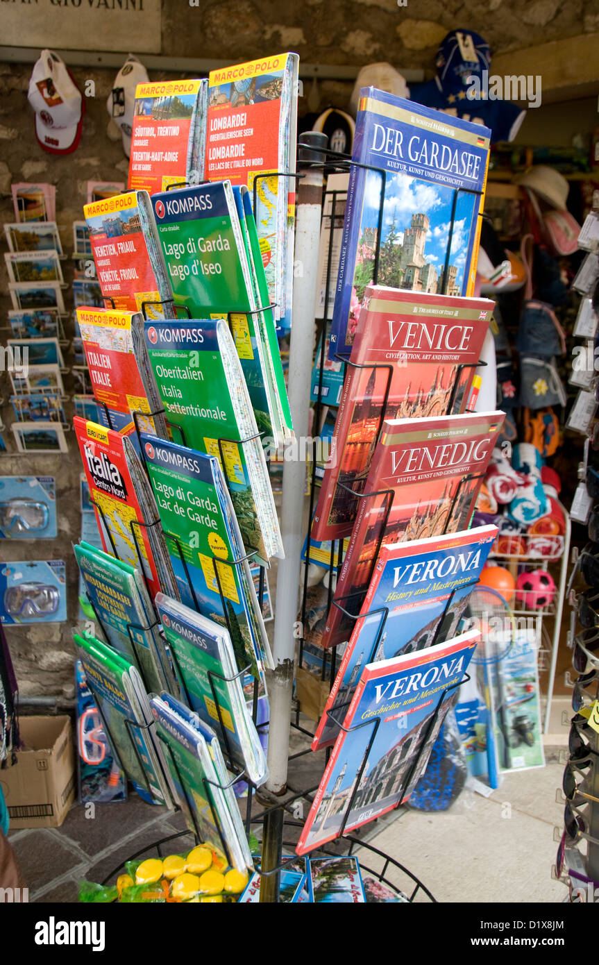 A rack of Italian road maps and guide books on sale in a small town of Garda on Lake Garda in the Veneto region of northern Italy Stock Photo