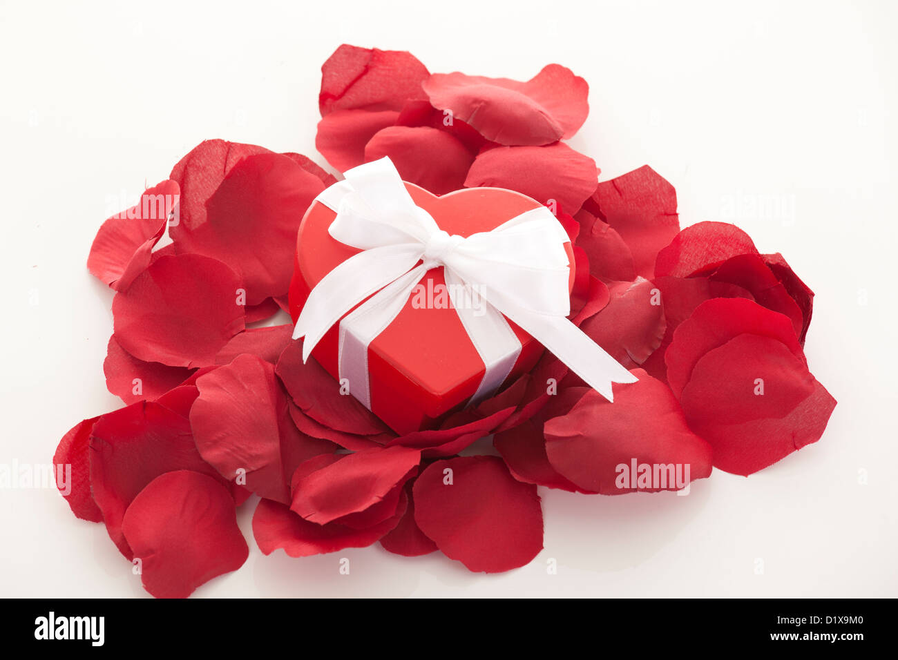 Valentines Day gift in red box with rose petal isolated on white Stock ...