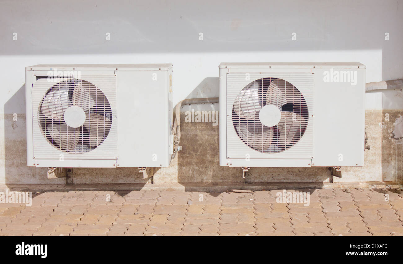 Air condition condensers outside the building with dirty wall Stock
