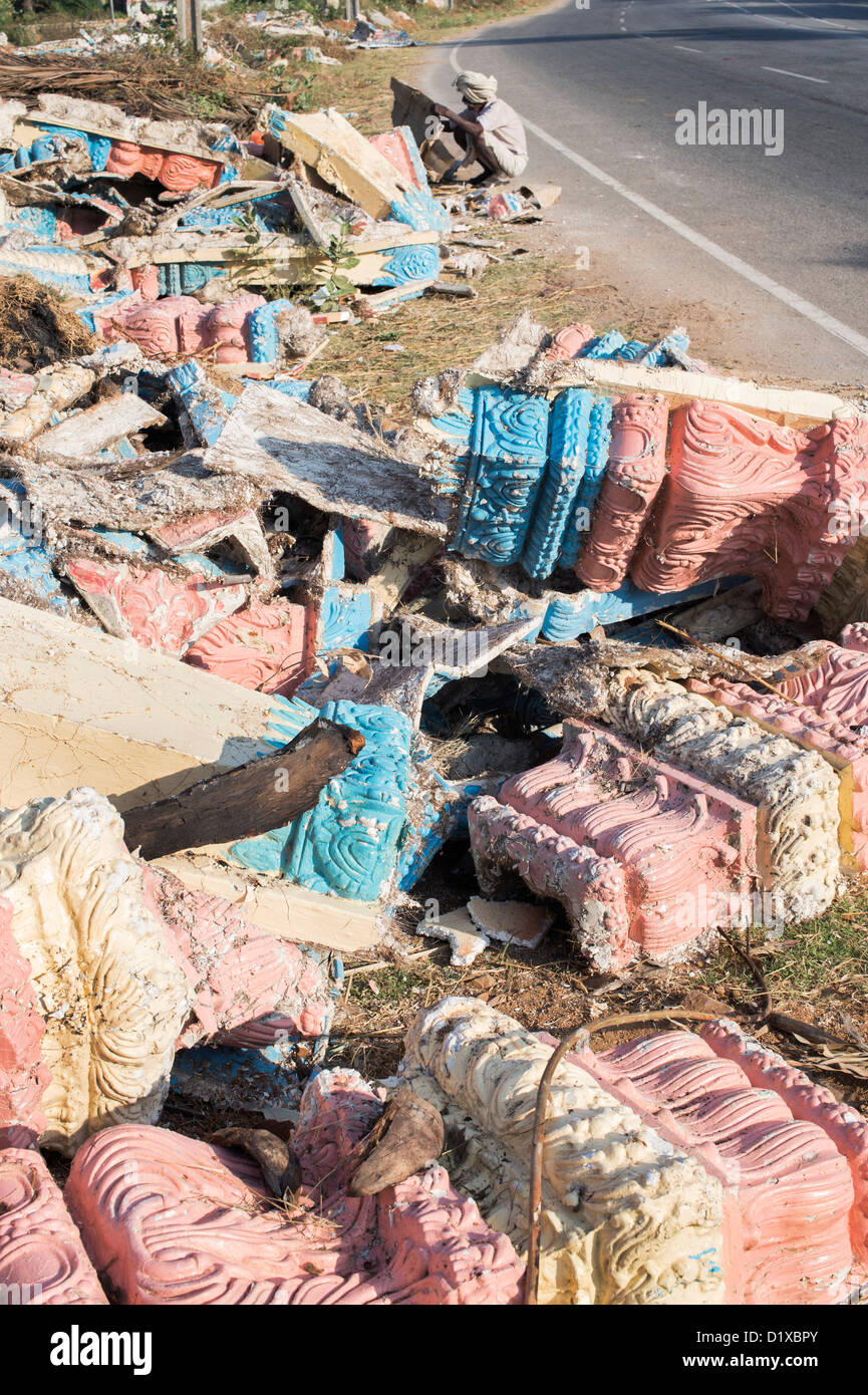 Indian man picking through discarded plaster moldings dumped on the roadside in India. Andhra Pradesh, India Stock Photo