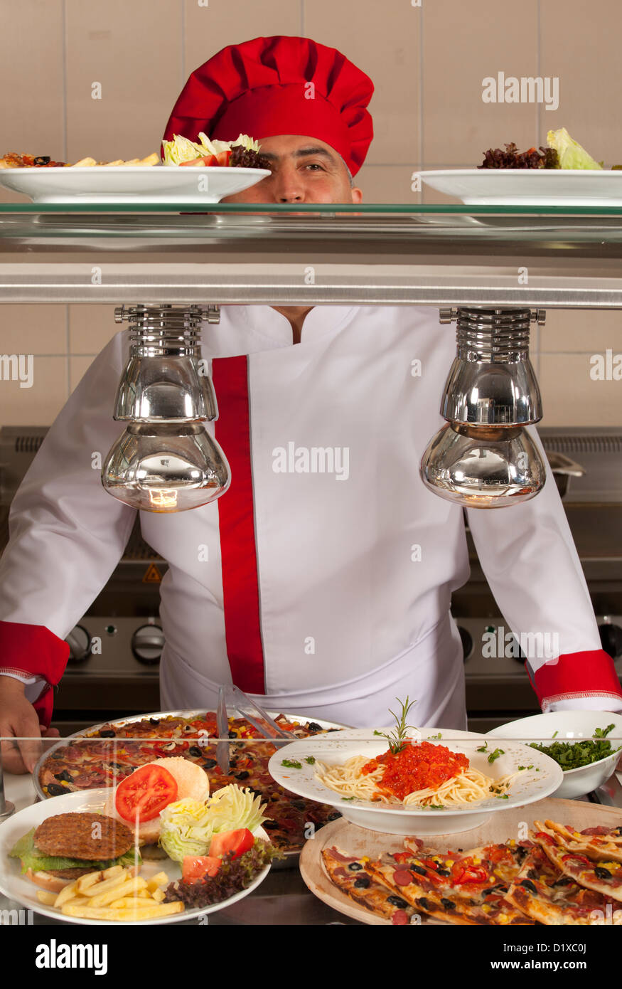 chef standing behind full lunch service station Stock Photo